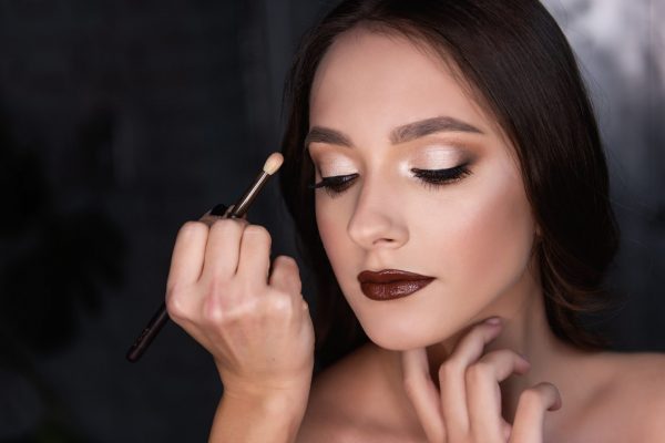 close-up-beauty-portrait-of-girl-makeup-artist-paints-with-brush-brunette-with-brown-eyes.jpg